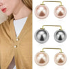 A set of gold-toned pearl drop earrings and a matching pearl brooch displayed against a neutral background.
