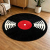 A round black rug with a red center and white sound wave patterns, placed on a wooden floor.
