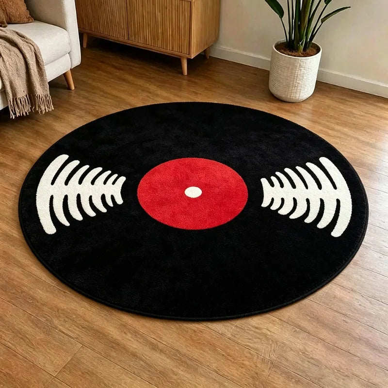 A round black rug with a red center and white sound wave patterns, placed on a wooden floor.
