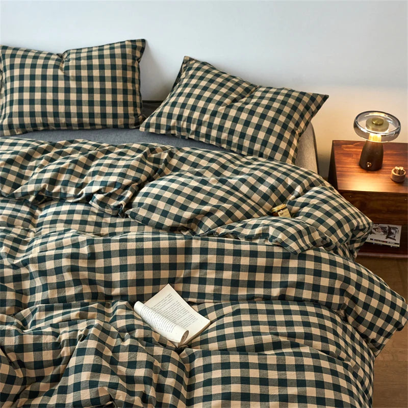 A plaid duvet cover set in olive green and beige tones with a checkered pattern displayed on a bed.