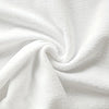 A close-up of a white plaid kitchen towel fabric, folded and draped.