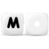 A white silicone alphabet bead shaped like the letter M and another blank bead.