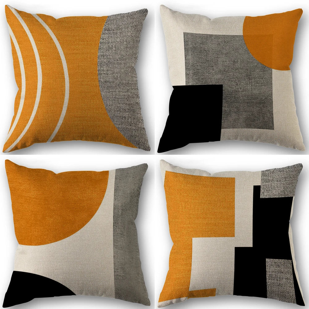 A set of four abstract geometric throw pillow covers in shades of black, white, gray, and burnt orange.