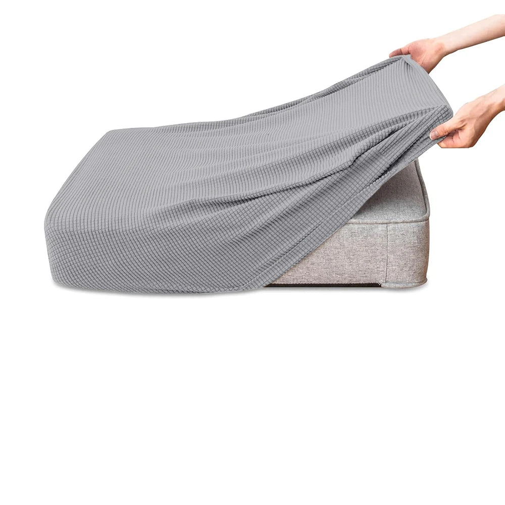 A gray polar fleece jacquard sofa seat cushion cover being held by a hand.
