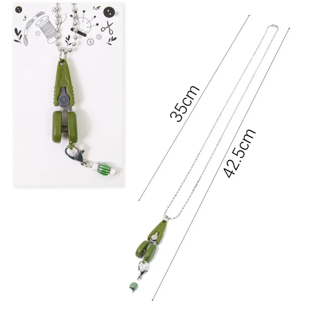 Mini precision sewing scissors with a protective cover displayed against a white background.