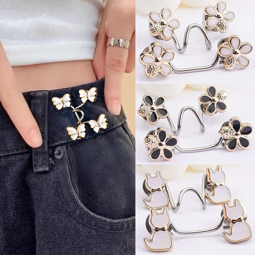 Silver and gold alloy button clips used for adjusting the waist of dark denim jeans