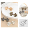 A collection of adjustable waist clip brooches in various gold and silver tones, featuring a four-leaf design.