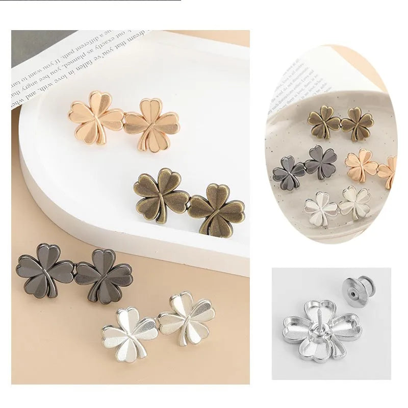 A collection of adjustable waist clip brooches in various gold and silver tones, featuring a four-leaf design.