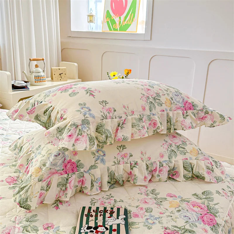 Two floral cotton pillow covers featuring pink and green roses on a white background.