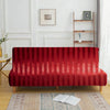 A deep red velvet sofa cover featuring vertical stripes placed on a wooden floor.