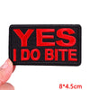 Black embroidered patch with red text saying YES I DO BITE