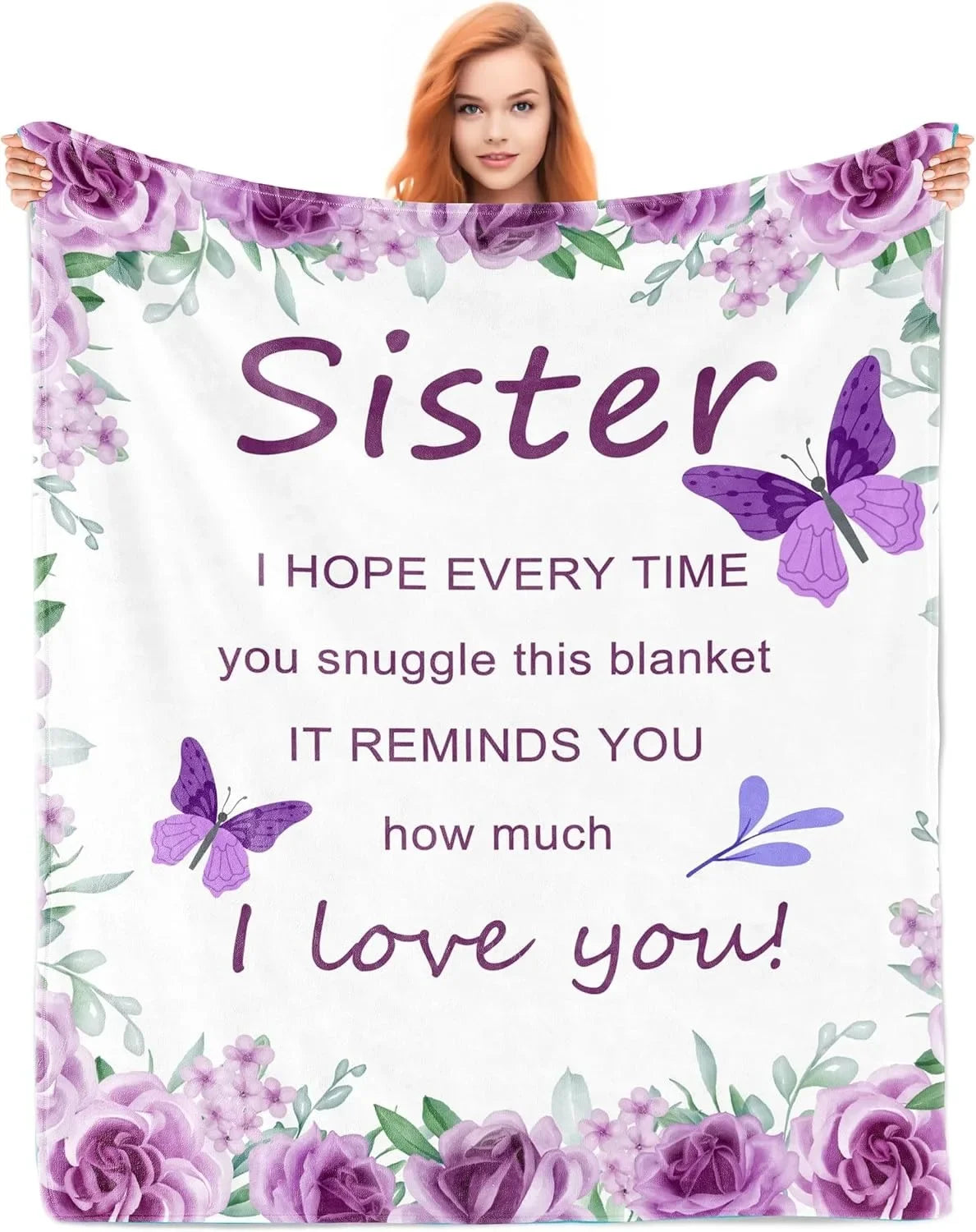 A woman holds a white blanket featuring purple floral designs and the text Sister I hope every time you snuggle this blanket 
