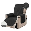 A black washable slipcover for a beige recliner sofa with an anti-slip strap visible.