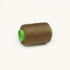 A spool of brown sewing thread with a bright lime green core.
