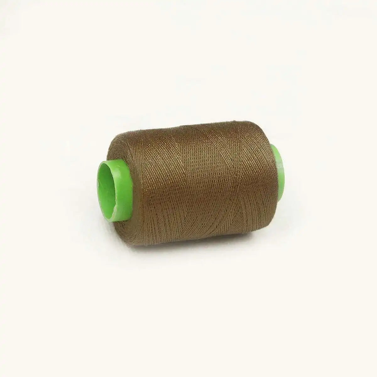 A spool of brown sewing thread with a bright lime green core.