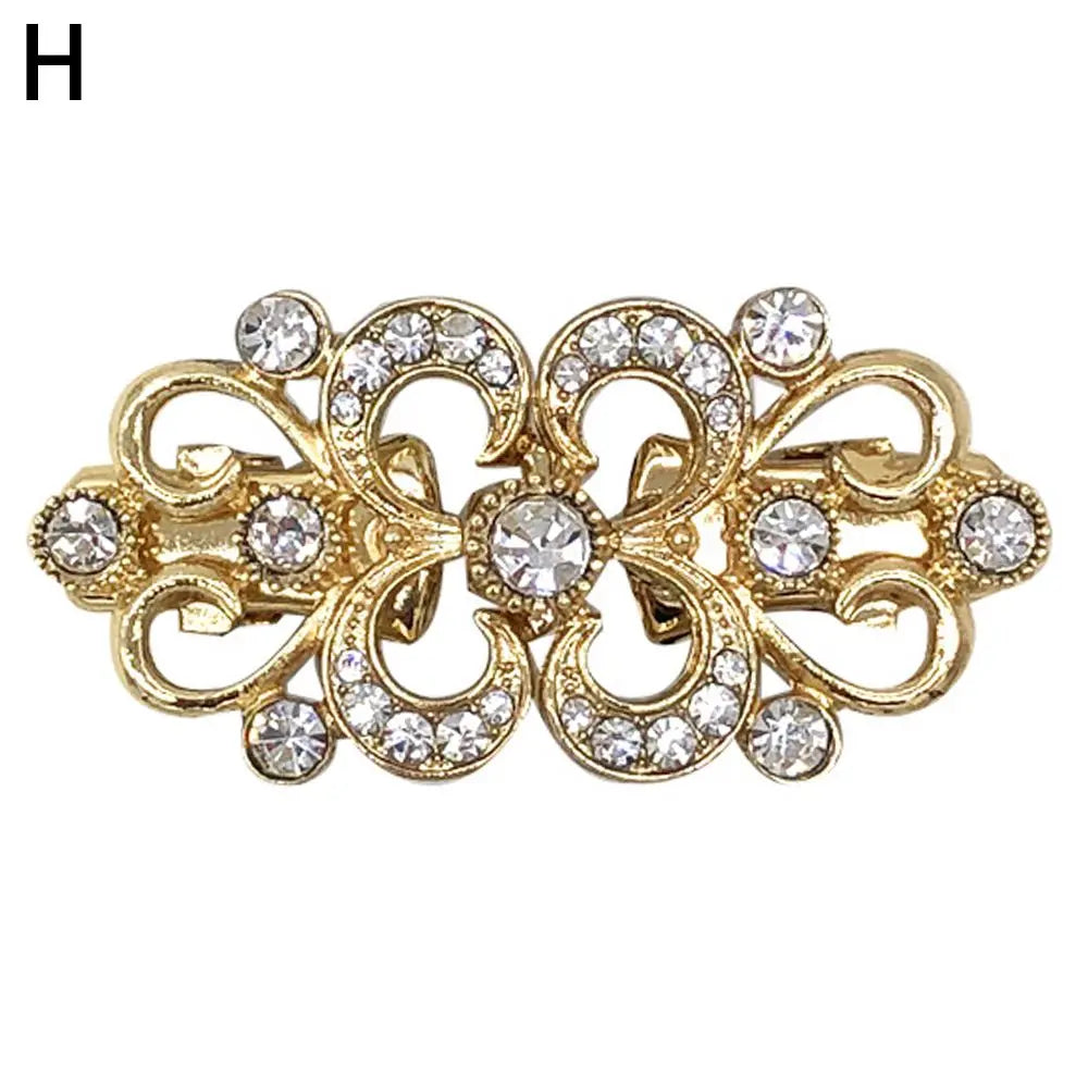 Gold vintage swirl clip brooch featuring clear rhinestones for scarves and clothing