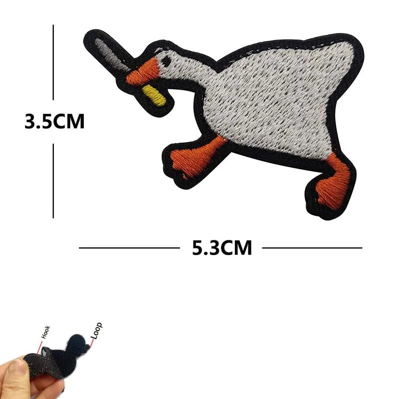 Embroidered tactical patch of a duck with an orange beak and body, showing its size.