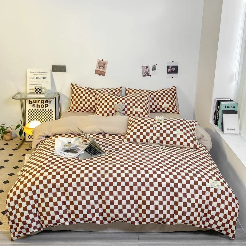 A bed dressed with a black and white plaid duvet cover set featuring brown and white checkered patterns.