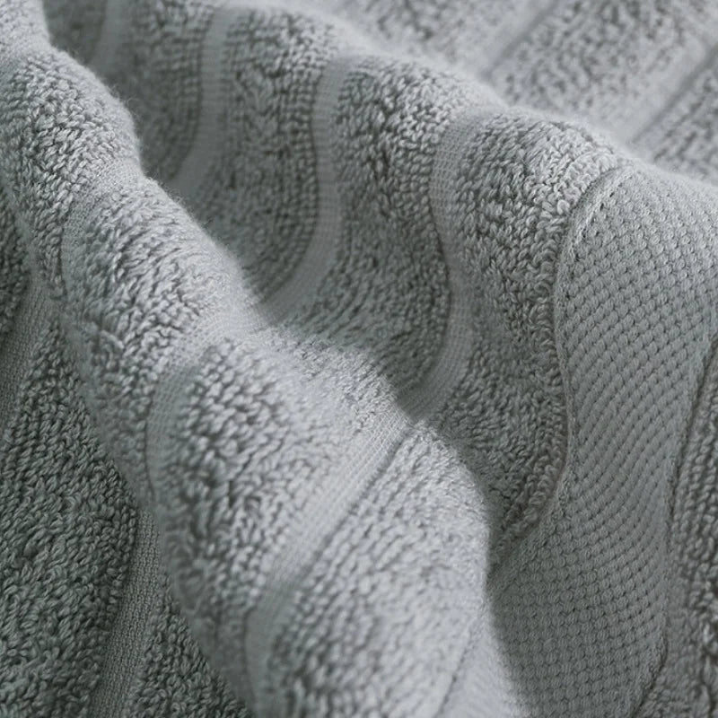 Close-up of a textured gray cotton face towel fabric folded and draped.