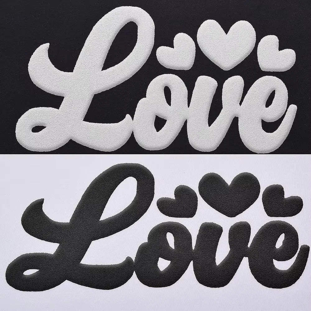 Black die-cut vinyl sheet featuring the words Love in a script font with heart accents.