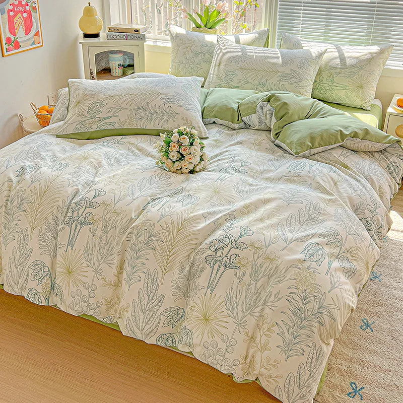 A floral printed bedding set featuring pale green and white patterns on a bed with matching pillows.