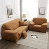 A tan faux silk sofa cover is displayed on a light rug in a bright room with a window and framed art.