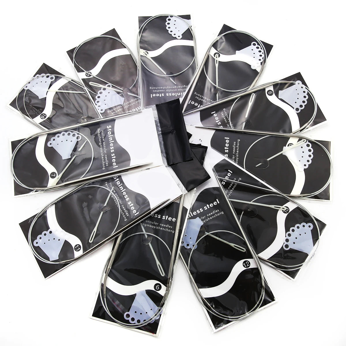 A set of stainless steel circular knitting needles with decorative tips, packaged in individual foil wrappers.