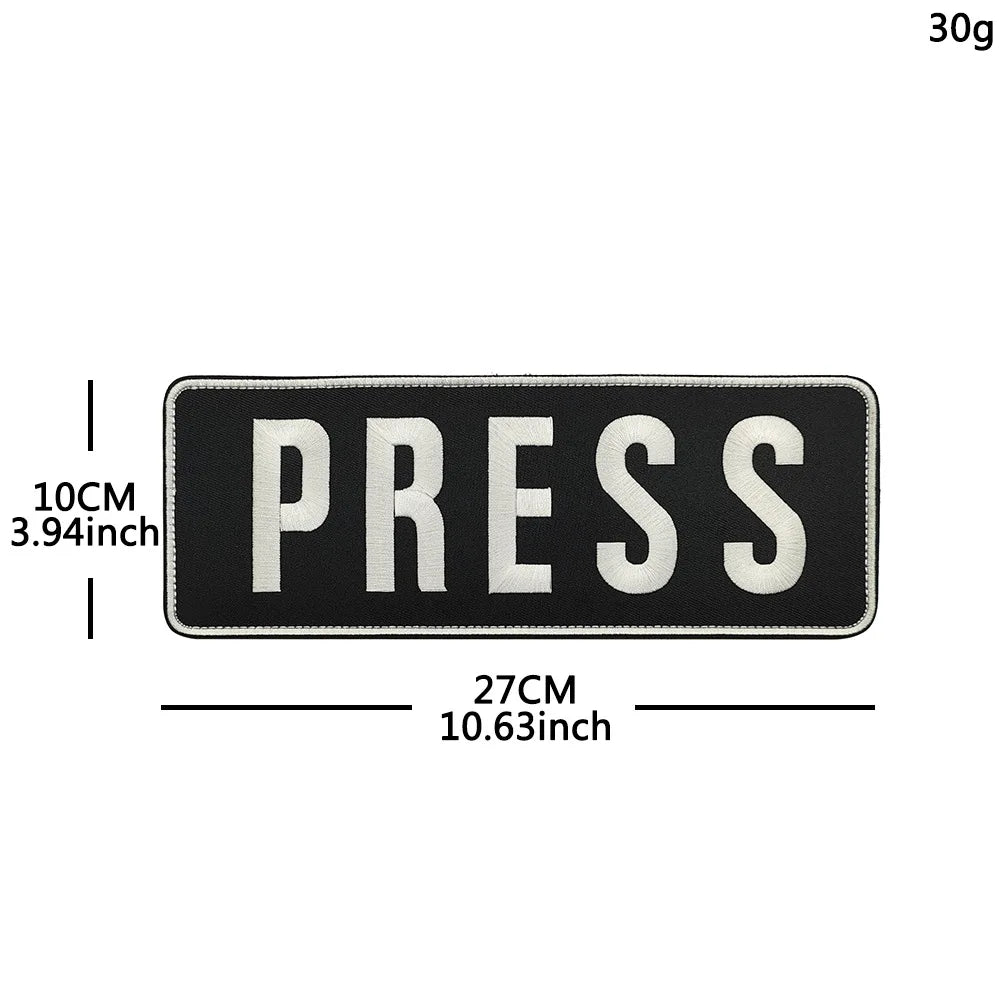 Black embroidered patch with the word PRESS in white text and hook and loop backing