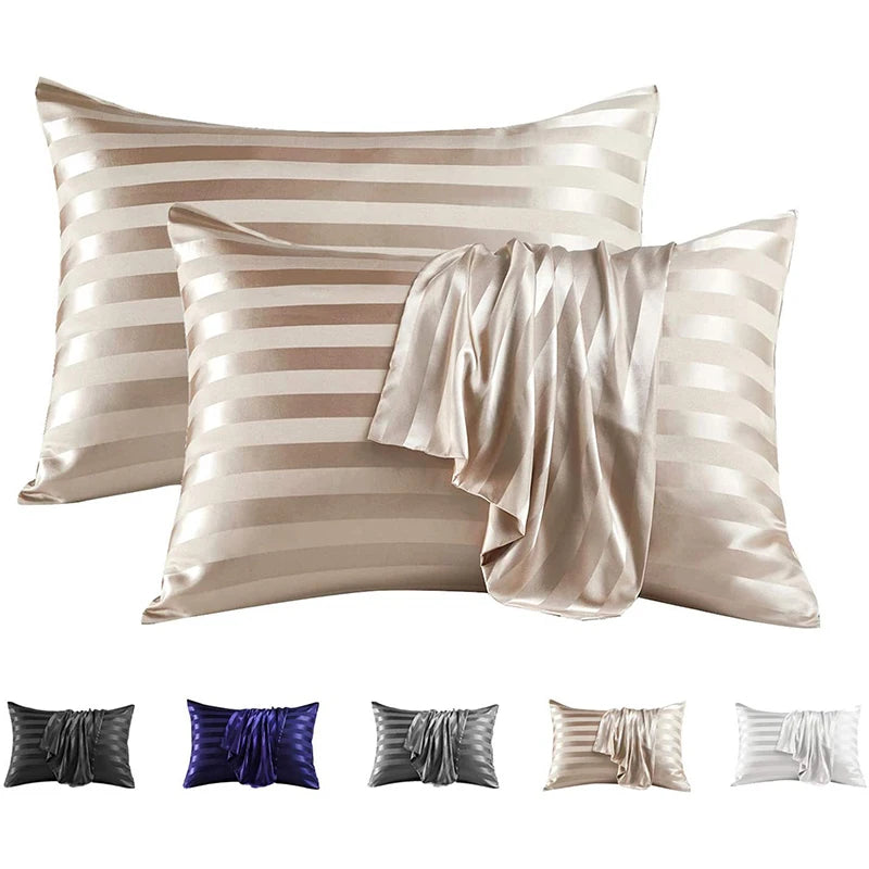 Set of elegant satin and silk striped pillow covers in beige and silver tones.
