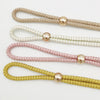Four strands of adjustable French ball curtain tiebacks in gold, white, pink, and yellow.