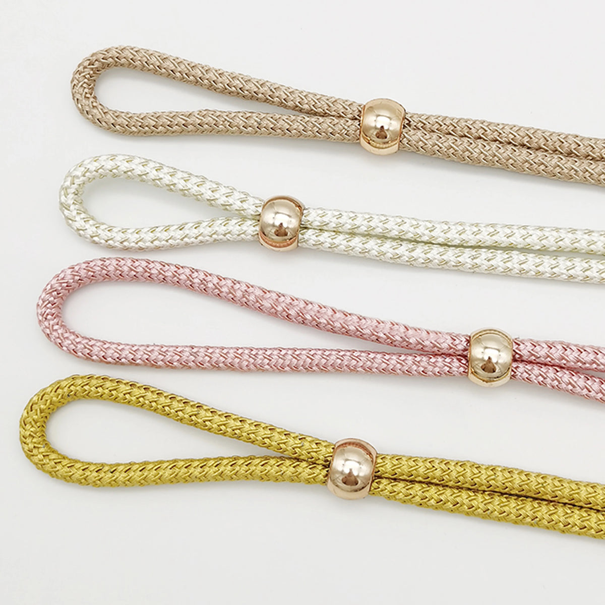 Four strands of adjustable French ball curtain tiebacks in gold, white, pink, and yellow.