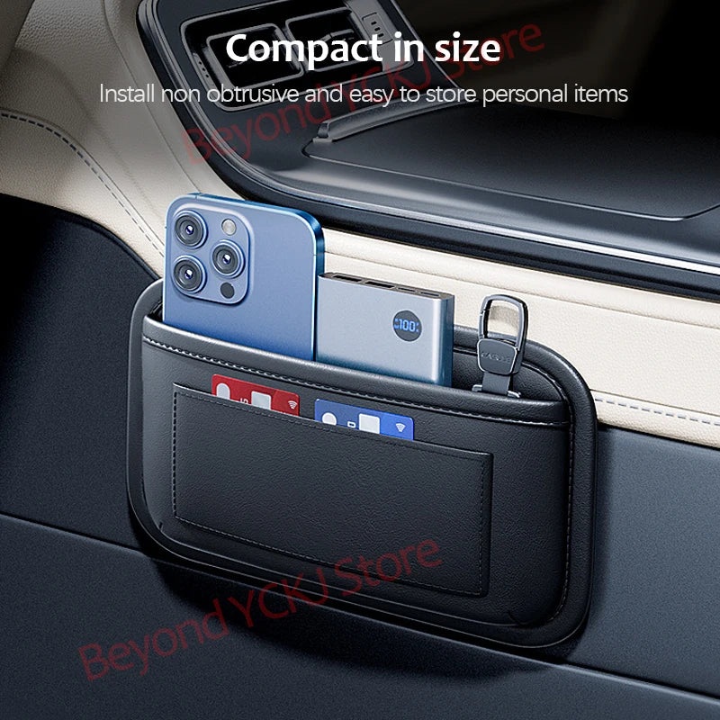 A black universal car organizer storage bag holding a smartphone and a card in a car interior.