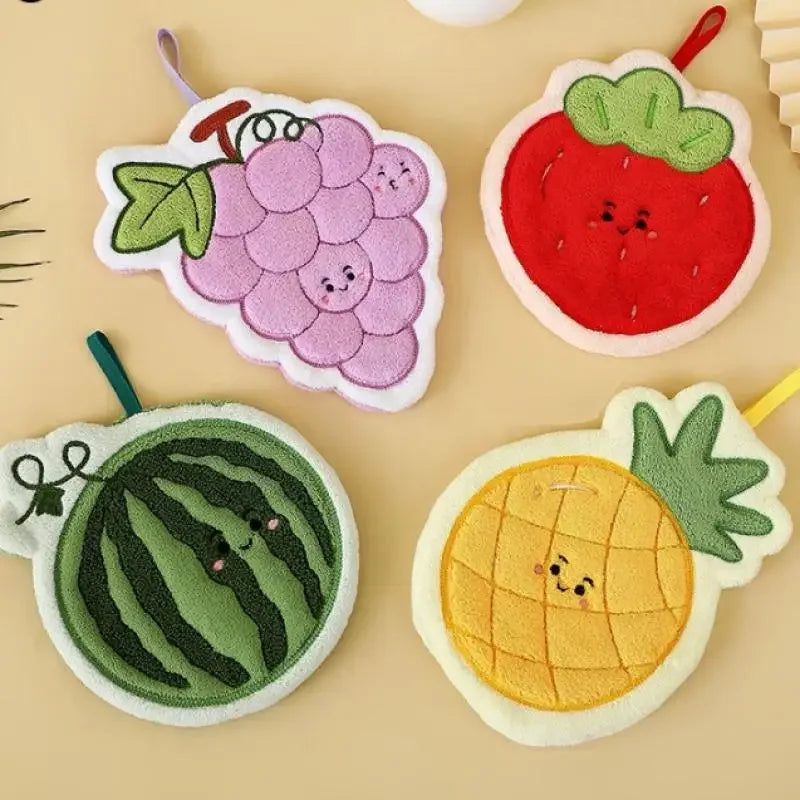 A collection of three floral fruit shaped coral fleece hanging hand towels: a purple grape, a red strawberry, and a yellow pi