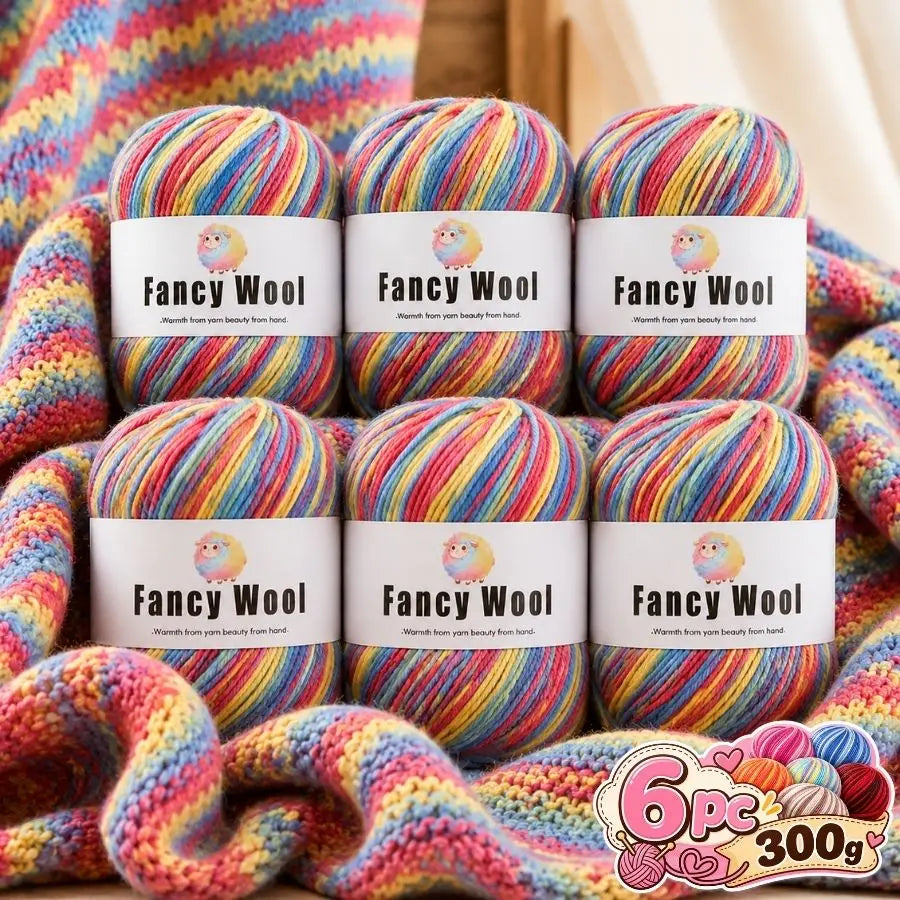 A set of six balls of fancy wool yarn in various multicolored gradients, packaged for knitting and crochet projects.
