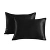 A pair of black satin pillowcases lying flat.