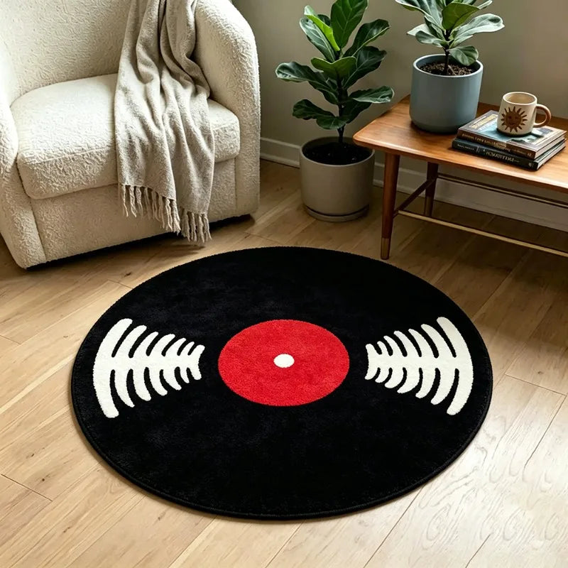 A round black rug featuring a red vinyl record design with white sound waves on a light wood floor.