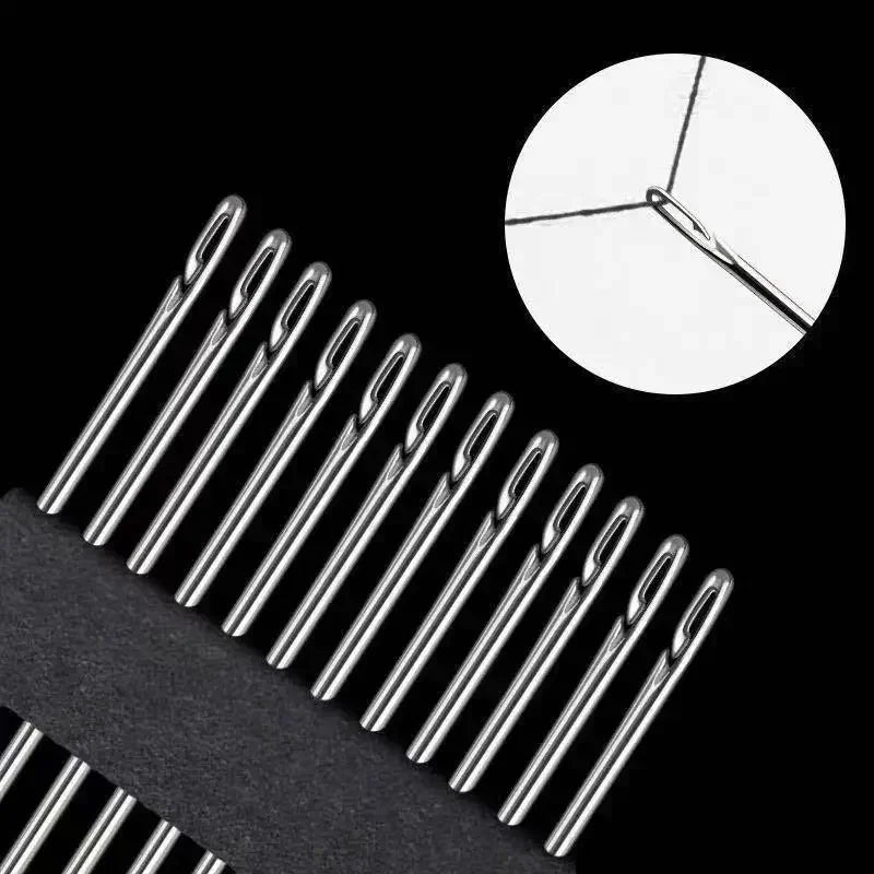 A close-up view of a stainless steel sewing kit with various size needles against a black background.
