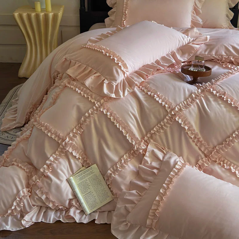 A pink ruffled duvet cover set with quilted detailing and gathered fabric is displayed on a bed.