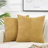 A set of retro corduroy patchwork pillow covers in a mustard yellow color.
