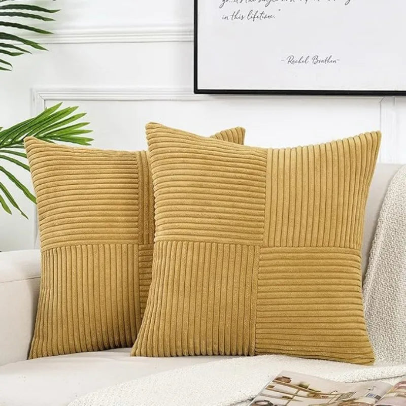A set of retro corduroy patchwork pillow covers in a mustard yellow color.