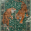 A richly patterned rug featuring tigers in various poses set against a deep green background.
