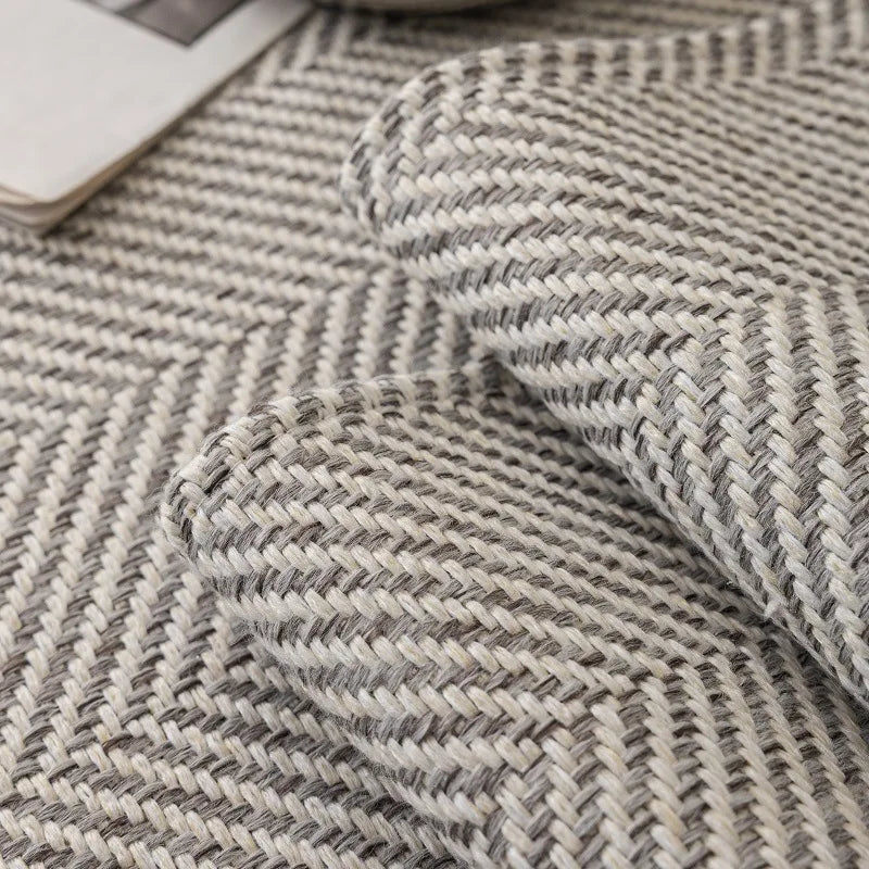 A close-up of a textured gray and white woven linen sofa cover cushion.