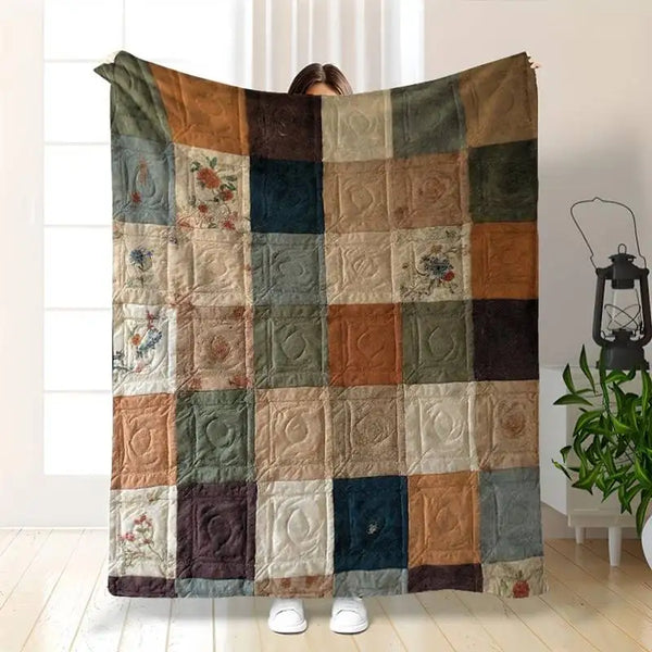 A vintage floral patchwork throw blanket featuring a grid pattern of muted earth tones and greens.