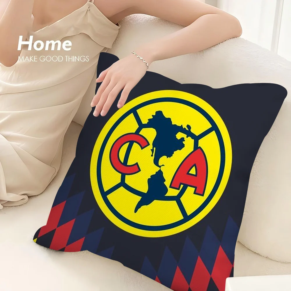 A decorative pillow case featuring a yellow circle with the letters CA inside, set against a dark blue background.
