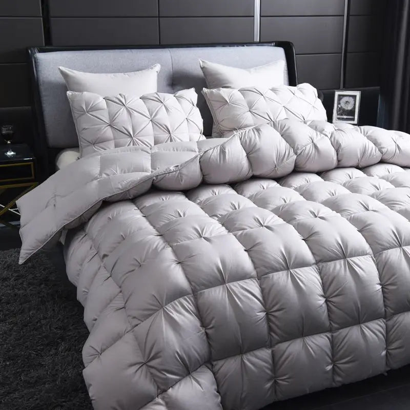 A white quilted luxury goose down duvet blanket on a bed.