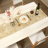 A white table runner with a gold pattern is set for a meal featuring a fried egg and a bottle of olive oil.