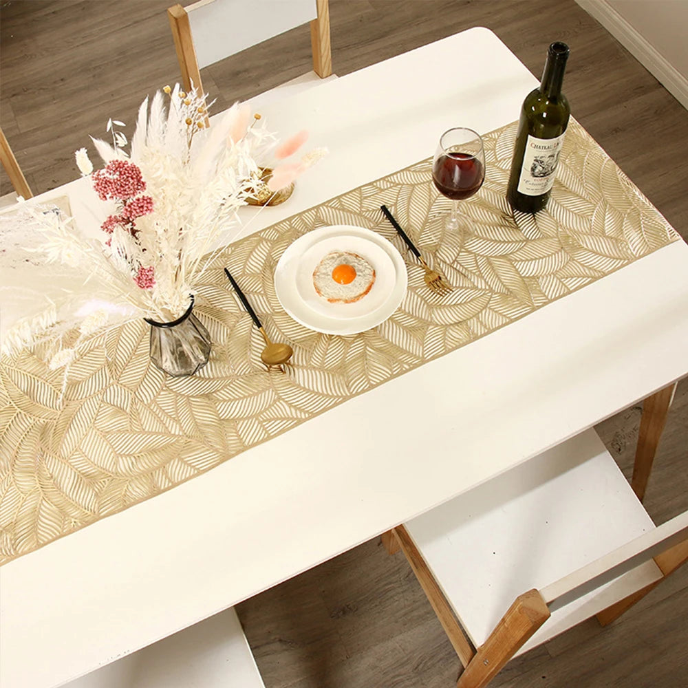A white table runner with a gold pattern is set for a meal featuring a fried egg and a bottle of olive oil.