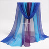 A display of flowing, sheer fabric scarves in shades of blue and purple for sensory play.