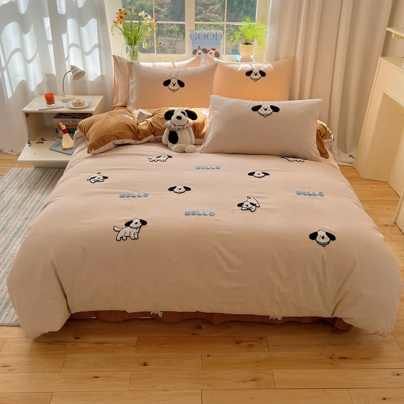 A beige embroidered bedding set featuring cartoon dog designs on a bed with light curtains.