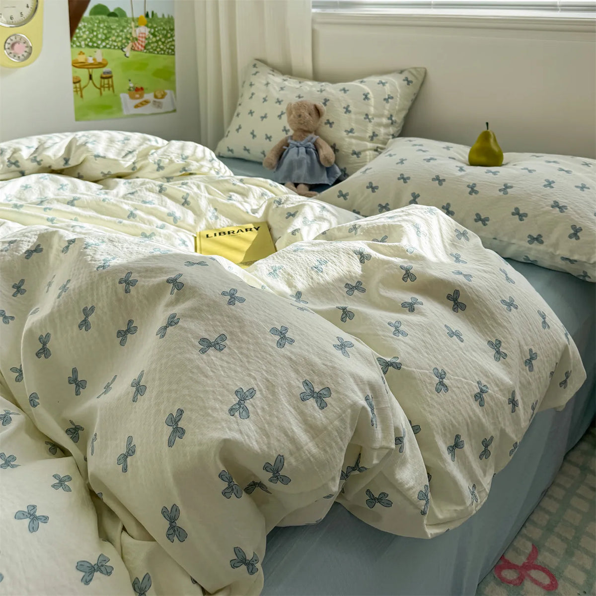 A white and blue floral microfiber duvet set is displayed on a bed, featuring a matching cover and pillows.